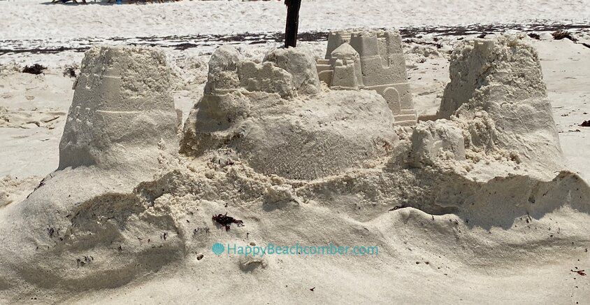 Sandcastle Being Washed Away by the Ocean