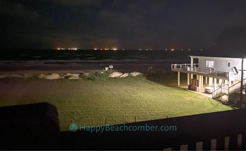 Ships anchored off Crystal Beach at night.